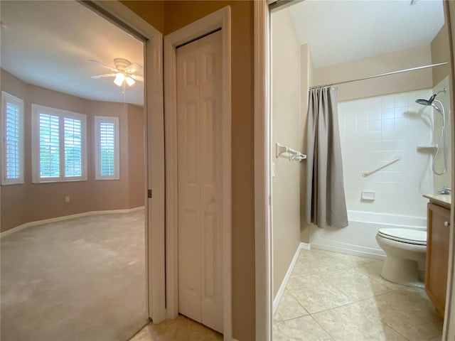 full bathroom featuring shower / bathtub combination with curtain, vanity, ceiling fan, toilet, and tile patterned floors