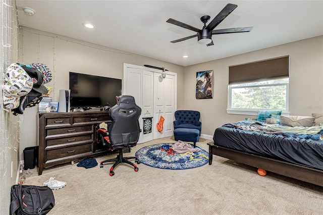 interior space with ceiling fan, a closet, and carpet floors