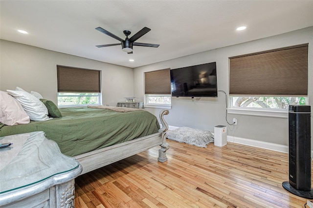 bedroom with light hardwood / wood-style flooring and ceiling fan