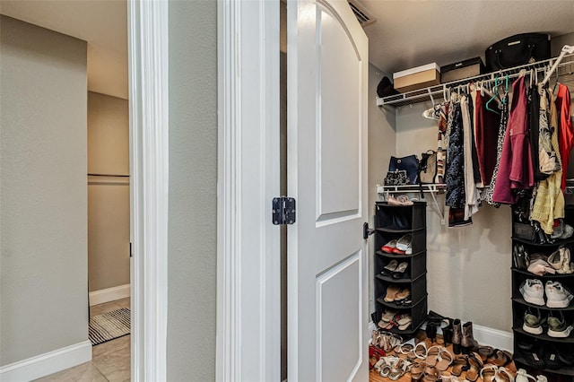 spacious closet featuring light tile floors
