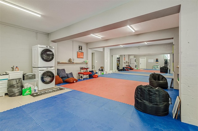 interior space featuring stacked washer and dryer and a textured ceiling