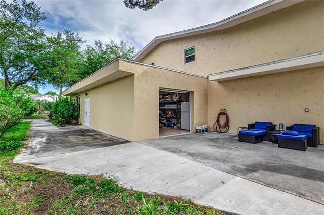 view of side of home with a patio area and a garage