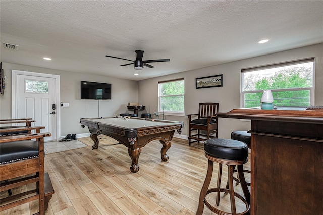 rec room featuring billiards, a textured ceiling, ceiling fan, and light hardwood / wood-style flooring
