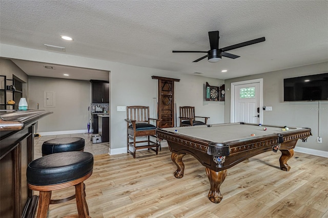 game room featuring ceiling fan, a textured ceiling, light wood-type flooring, and pool table