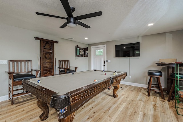 rec room featuring billiards, ceiling fan, a textured ceiling, and light hardwood / wood-style floors