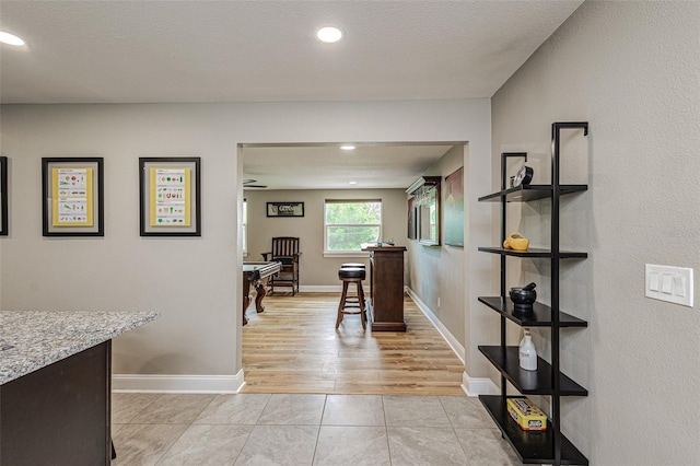 dining space with light tile flooring, ceiling fan, and a textured ceiling
