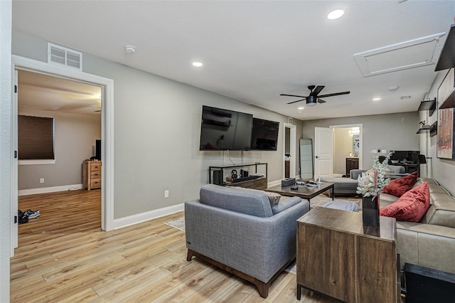 living room with ceiling fan and light hardwood / wood-style flooring