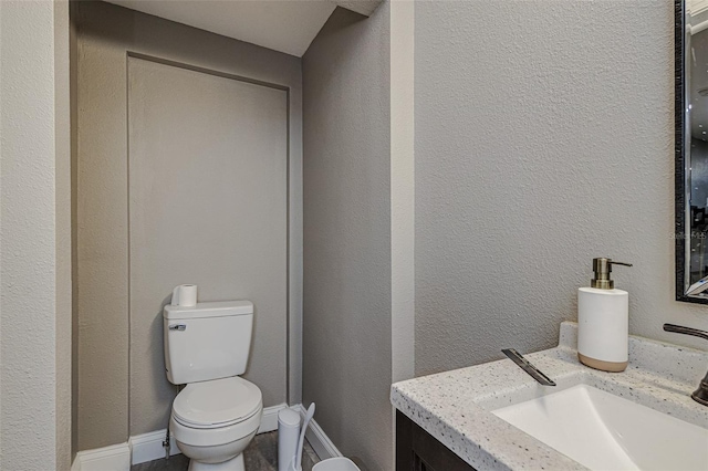bathroom featuring toilet and vanity
