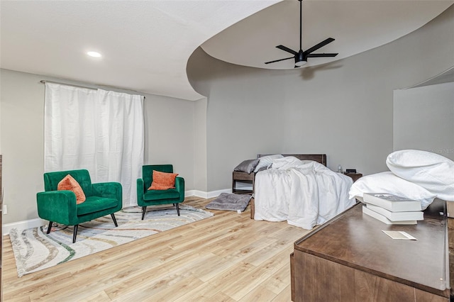 bedroom with ceiling fan and light hardwood / wood-style flooring