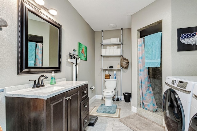 bathroom with independent washer and dryer, tile flooring, toilet, and oversized vanity