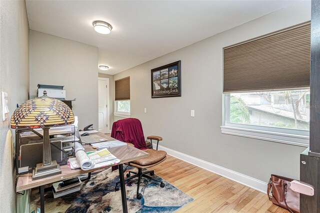 office area with light hardwood / wood-style floors