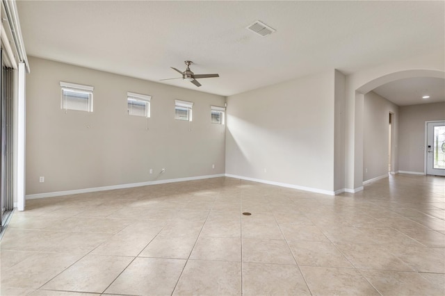 spare room featuring light tile flooring and ceiling fan