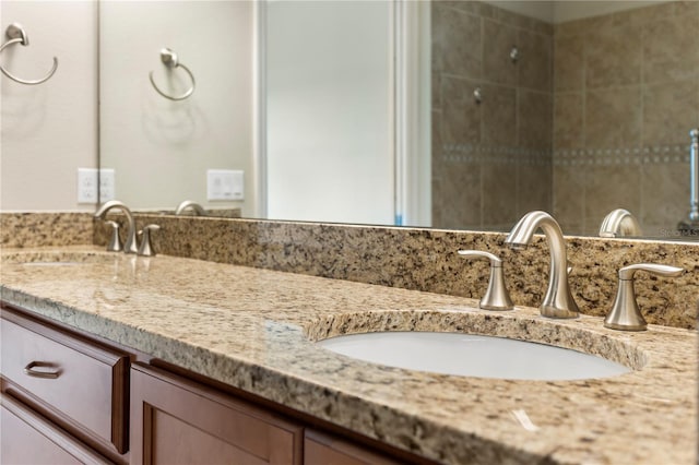 bathroom with dual sinks and vanity with extensive cabinet space