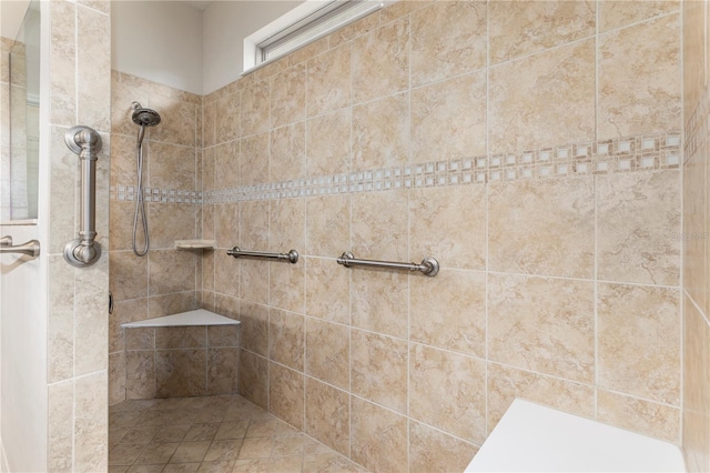 bathroom with a tile shower