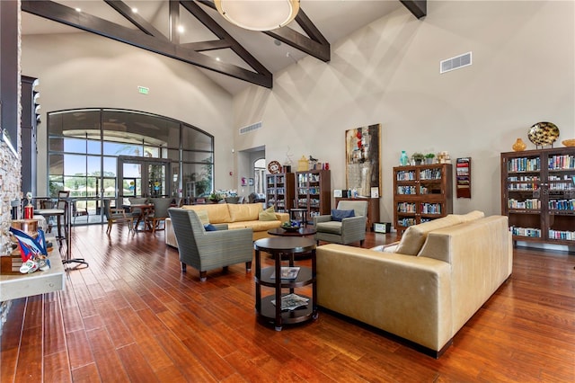 living room featuring high vaulted ceiling, dark hardwood / wood-style flooring, and beamed ceiling