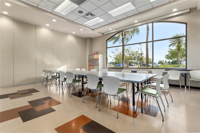 dining room featuring a paneled ceiling and a wealth of natural light