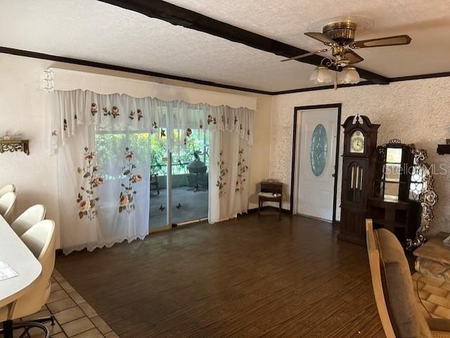 unfurnished living room with ceiling fan, a textured ceiling, and hardwood / wood-style floors