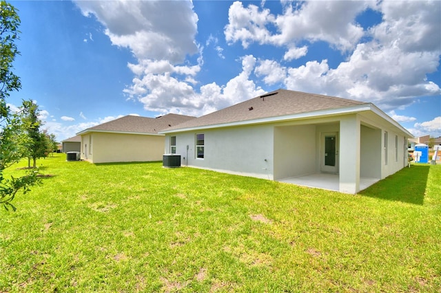 back of property featuring a yard, central AC, and a patio