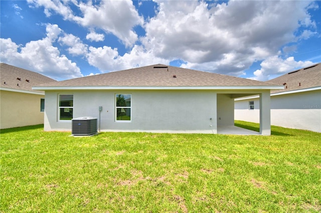 back of house featuring a lawn, central AC, and a patio