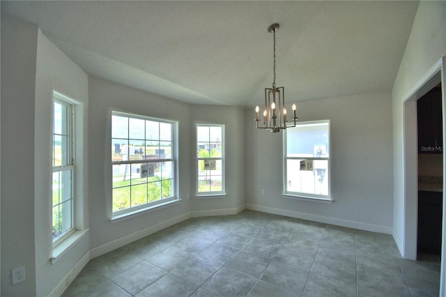 unfurnished dining area featuring a chandelier, vaulted ceiling, a healthy amount of sunlight, and light tile flooring