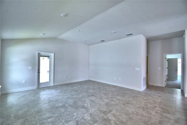 tiled empty room with vaulted ceiling