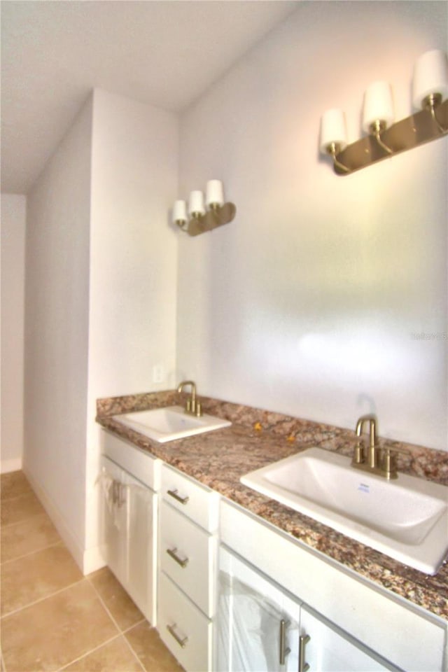 bathroom with dual vanity and tile flooring