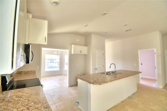 kitchen featuring an island with sink, a notable chandelier, white cabinetry, and sink