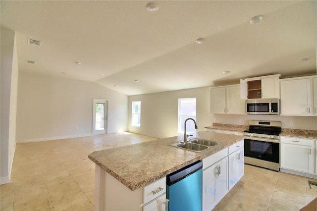 kitchen featuring an island with sink, sink, stainless steel appliances, light tile flooring, and white cabinetry