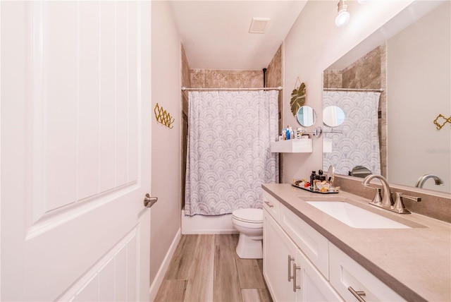 bathroom with hardwood / wood-style floors, oversized vanity, and toilet