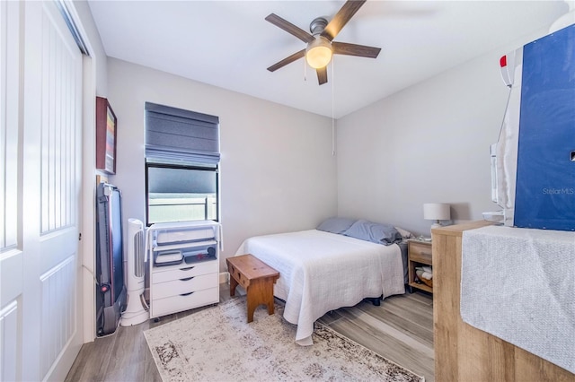 bedroom with light hardwood / wood-style floors and ceiling fan