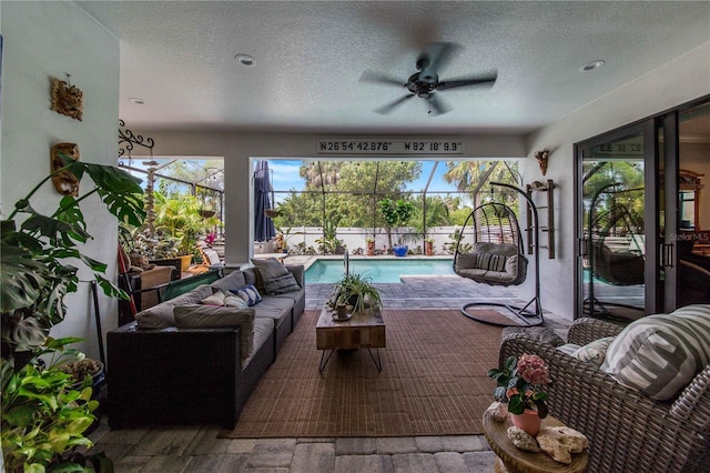 exterior space featuring a textured ceiling and ceiling fan