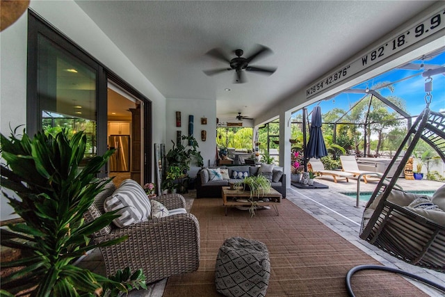 view of terrace featuring an outdoor hangout area, ceiling fan, and glass enclosure