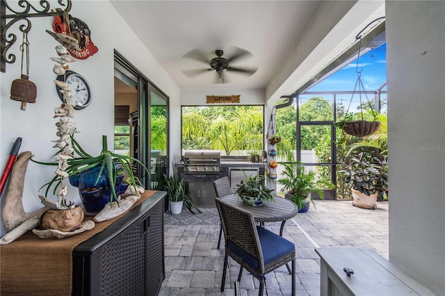 sunroom featuring ceiling fan