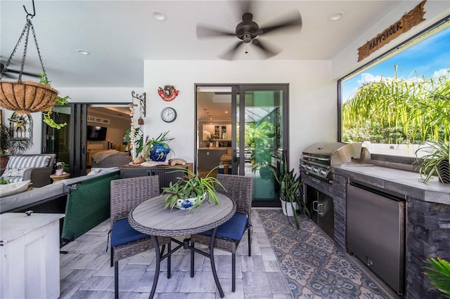 view of terrace featuring area for grilling, outdoor lounge area, ceiling fan, and exterior kitchen