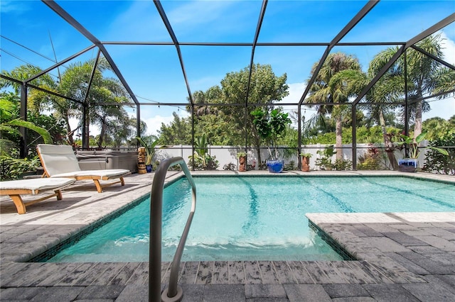 view of pool featuring a patio area and glass enclosure