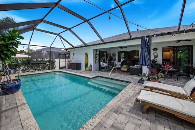 view of swimming pool with a patio area, an outdoor hangout area, ceiling fan, and a lanai