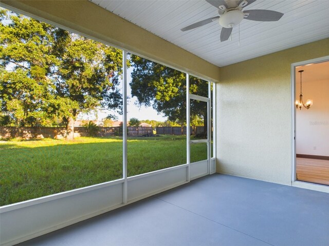 unfurnished sunroom featuring ceiling fan