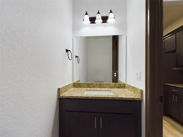 bathroom featuring hardwood / wood-style flooring and vanity