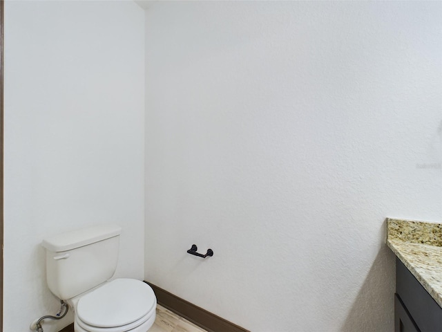 bathroom with toilet and vanity