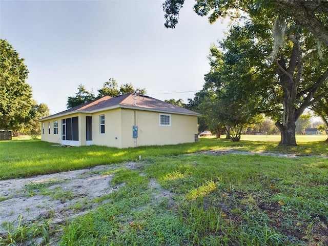 view of property exterior with a yard