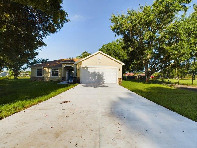 ranch-style home with a garage and a front lawn