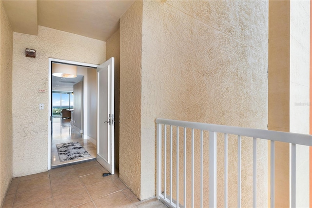 hallway featuring light tile floors