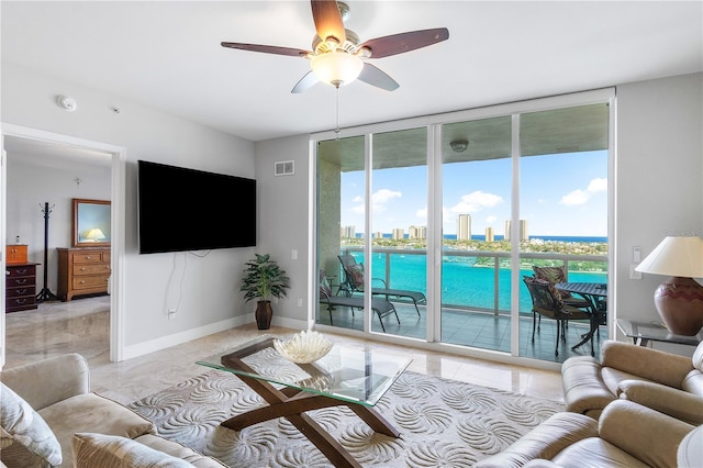 tiled living room with ceiling fan