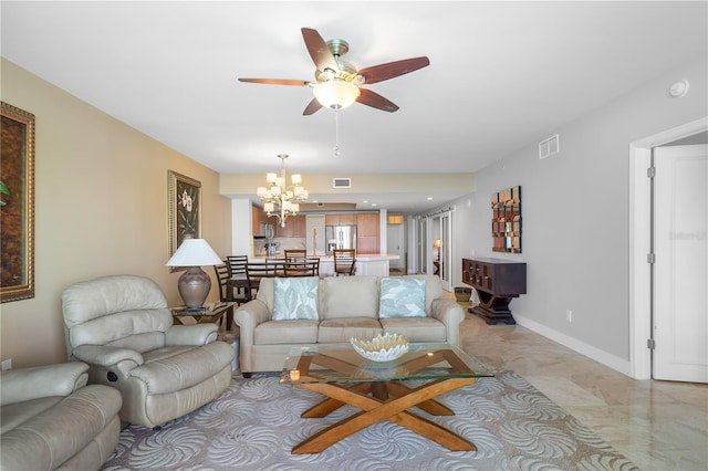 living room featuring light tile floors and ceiling fan with notable chandelier