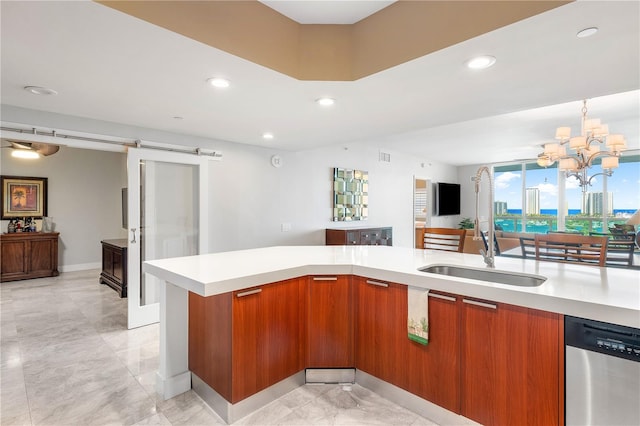 kitchen featuring stainless steel dishwasher, light tile floors, a notable chandelier, a barn door, and sink