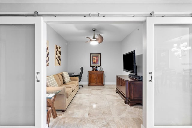 living room featuring a barn door, ceiling fan with notable chandelier, and light tile floors