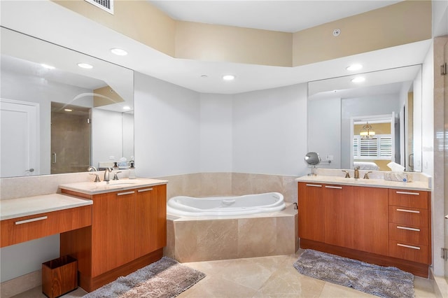 bathroom featuring tile flooring, a relaxing tiled bath, and double vanity