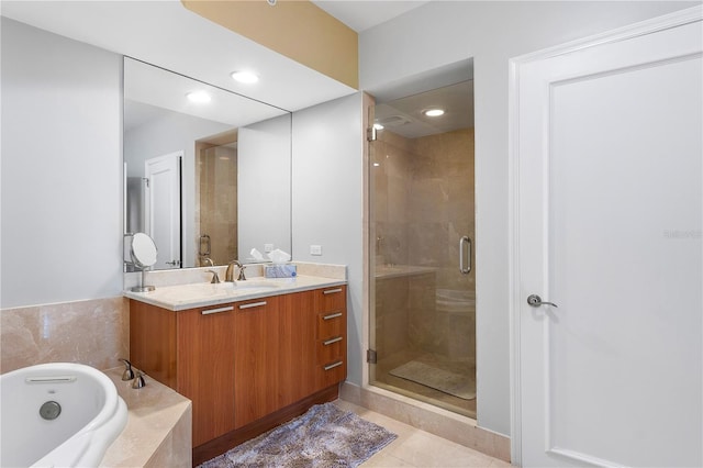 bathroom featuring vanity, tile flooring, and separate shower and tub