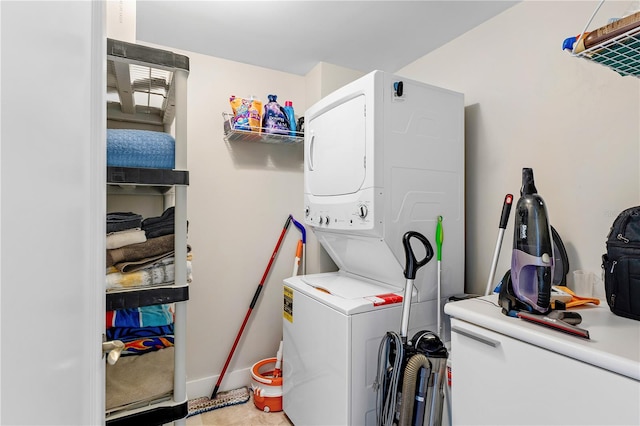 clothes washing area featuring stacked washer / drying machine