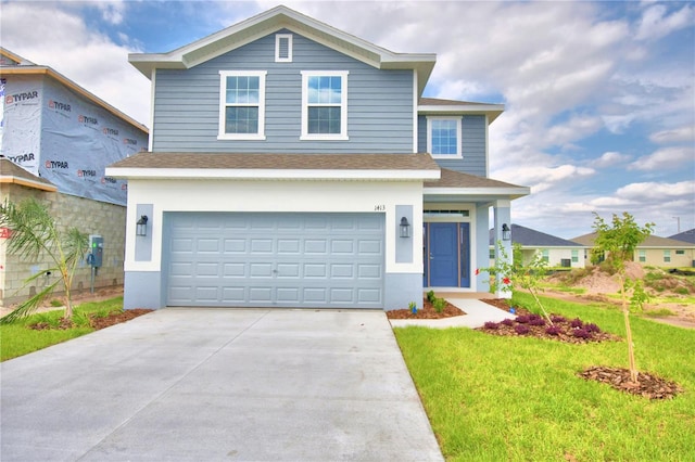 view of front property featuring a front lawn and a garage